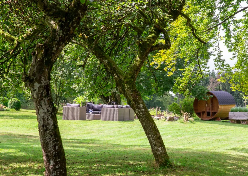 Buitenzicht op de Ardense cottage uit 1830 met tuin en bossen